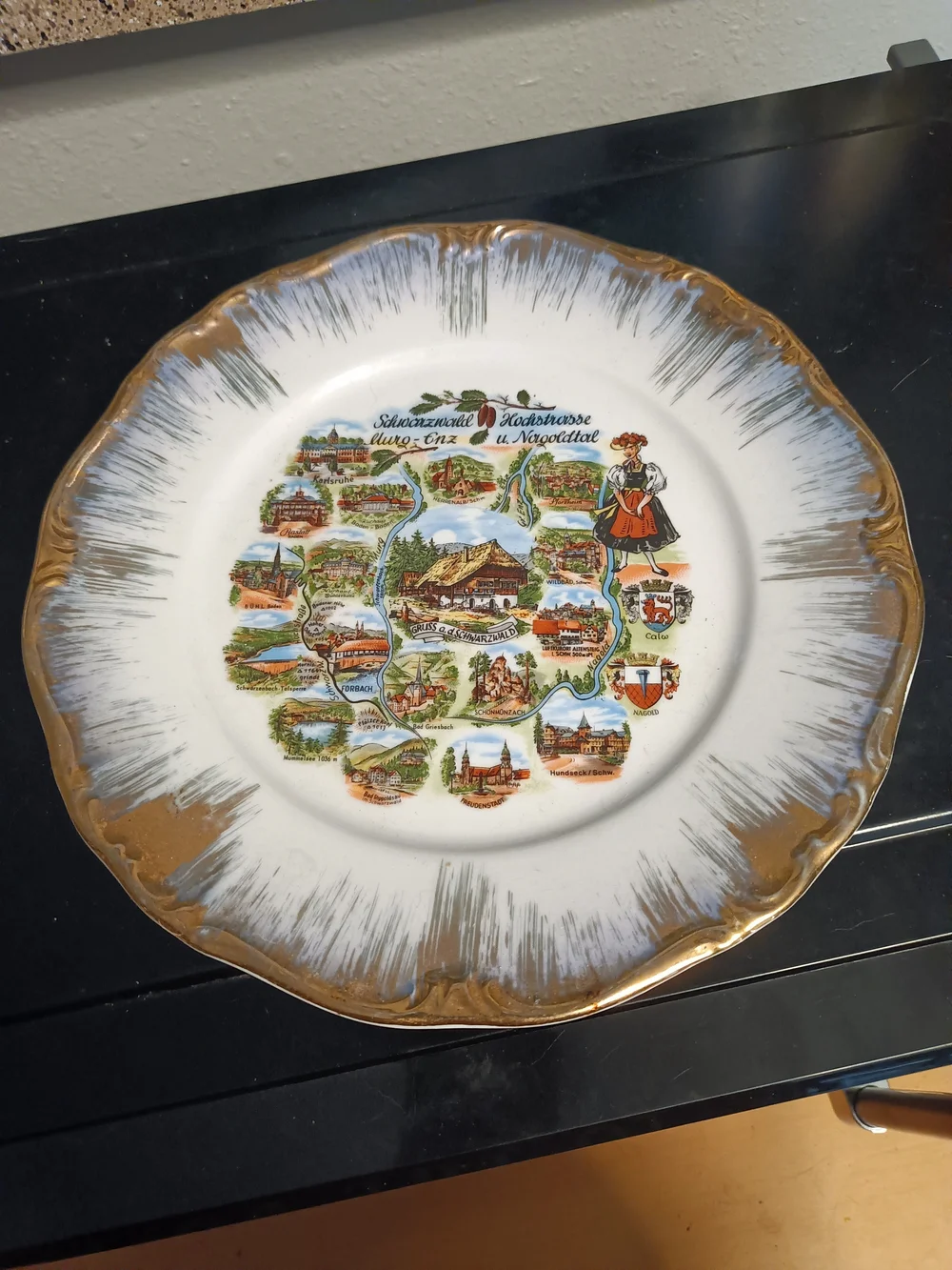 Decorative White and Gold Souvenir Plate with Scenic Black Forest Motif